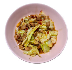 Stir-fried cabbage with oyster sauce and chili, Thai style Stir-fried vegetable and minced pork in pink bowl plate isolated