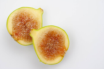 Fresh fig halves showing juicy texture and seeds
