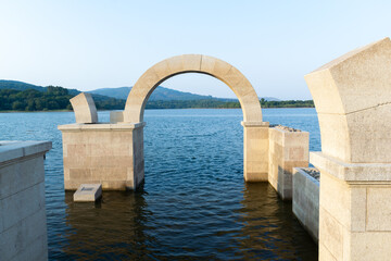 Roman arch of Aquis Querquennis submerged in the lake. Ourense, Spain