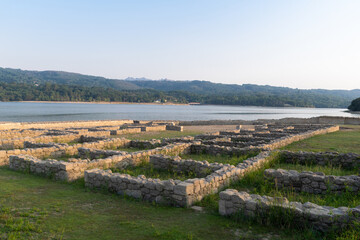 Roman ruins of Aquis Querquennis in Ourense, Spain, near the Limia River. An ancient archaeological site with stone walls, historical heritage, and a picturesque natural landscape.
