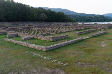 Ancient Roman ruins of Aquis Querquennis in Ourense, Spain. Archaeological site with stone structures, historical heritage, and scenic natural surroundings by the Limia River.