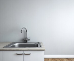 A stainless steel sink and faucet are featured against a light gray wall in a modern kitchen.