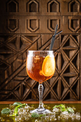 Refreshing cocktail with orange slice and ice.