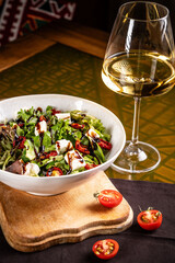 Fresh salad with feta, sun-dried tomatoes, and balsamic dressing.
