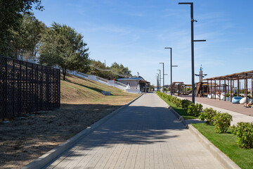 A path made of granite slabs on the Taman Embankment in summer
