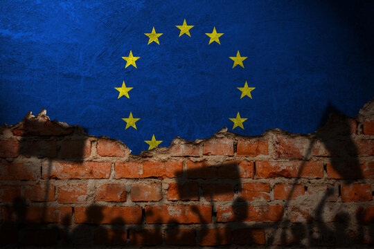 European union flag painting on brick wall and Protesters shadow