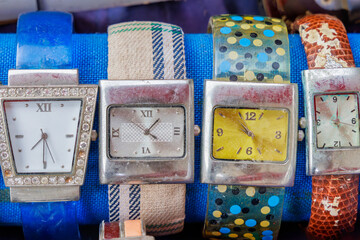 Four retro colourful wristwatches on a flea market