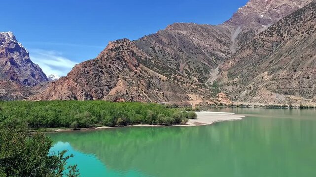 A trip to the picturesque Iskanderkul mountain lake in Tajikistan on the northern slopes of the Gissar range in the Fan Mountains. Beautiful rocky slopes and a green lake