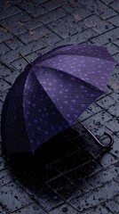 A dark purple umbrella with a small-square patterned canopy rests on a wet, dark gray cobblestone pavement.  Rain droplets are visible on the ground and the umbrella's surface, casting a subtle shadow