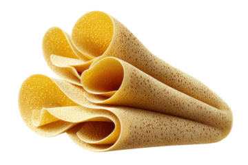 Close-up of rolled golden injera bread with bubble texture on black background, cut out
