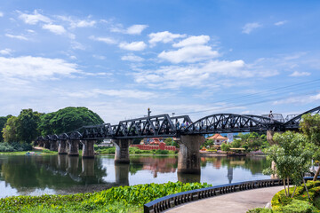 River Kwai bridge historical landmark in Kanchanaburi Thailand under blue sky