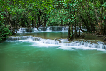 Tropical waterfall in lush forest with emerald water, Huay Mae Khamin National Park, Tier 2 Man Khamin, Kanchanaburi, Thailand