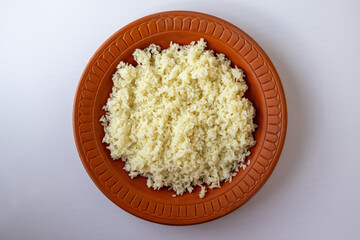 Plain white rice, a Bangladeshi staple, in a traditional clay plate. This top-down view highlights the simple, rustic presentation of a classic meal.