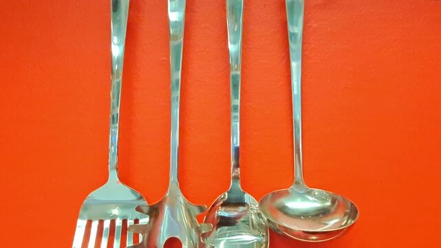 Getting ready to cook. A slow tilt-down reveals the details of professional cooking tools against a vibrant background.