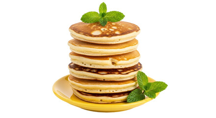 Isolated delicious stack of pancakes served on yellow plate, topped with fresh mint leaves