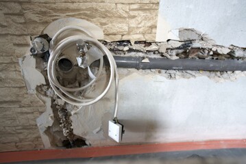 The plumbing work is currently in progress, showcasing exposed pipes and a bare floor in a bathroom renovation project