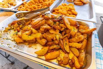 Trays of crispy fried onion rings, chicken nuggets, and French fries