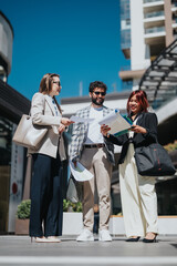 A diverse team of business professionals having a collaborative discussion outside in a city area.