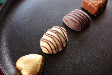 Assorted Chocolate candy brown white and dark in the shape of heart. Box with delicious set of many different chocolate candies.