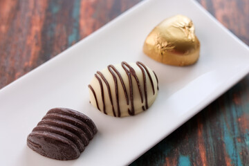 Assorted Chocolate candy brown white and dark in the shape of heart. Box with delicious set of many different chocolate candies.