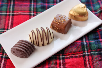 Assorted Chocolate candy brown white and dark in the shape of heart. Box with delicious set of many different chocolate candies.
