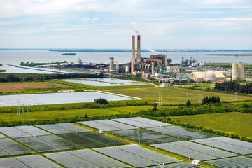 Aerial view of sustainable energy development at Florida Big Bend Power Station. Solar panels symbolize the shift from traditional fossil fuels to clean, emission-free electricity production © bilanol