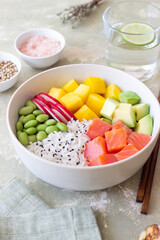 Hawaiian poke bowl with rice, salmon, avocado, radish, edamame and mango. Healthy eating. Diet.