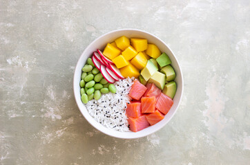 Hawaiian poke bowl with rice, salmon, avocado, radish, edamame and mango. Healthy eating. Diet.