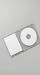 cd and dvd, Open clear plastic CD jewel case with blank white disc and insert for branding. Mock-up of compact disc packaging on soft gray background. Represents digital storage, music or software.