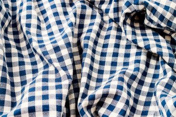 Abstract background with checkered blue and white fabric.