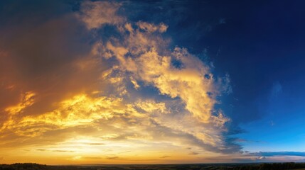 Fototapeta premium A panoramic view of a dramatic sunset or sunrise with golden sunlight illuminating clouds over a landscape of trees and 