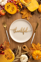Vertical view of a Thanksgiving table setting showcasing harvest elements and festive autumn decor