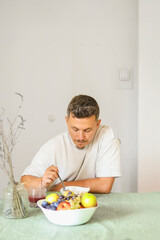 Casual Morning Routine: Adult Male Eating Muesli in Modern Dinning Room.