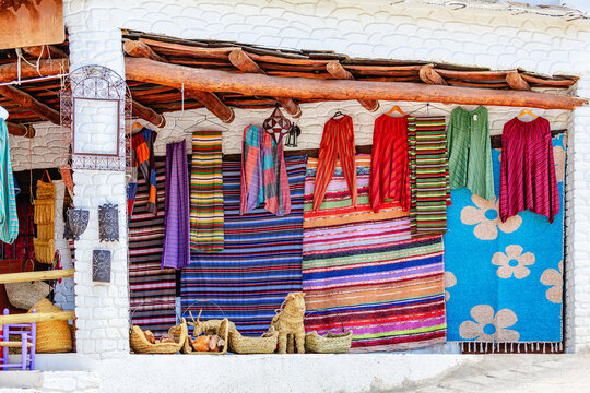 Colorful textiles displayed outside a local market in a village Capileira.