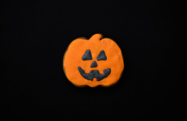 Halloween gingerbread cookies on a dark background. Bright homemade cookies for Halloween party. Halloween background with space for text. Top view. Mock up