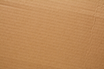 Brown cardboard box, beautiful patterned hardcover, scrap paper and brown background.