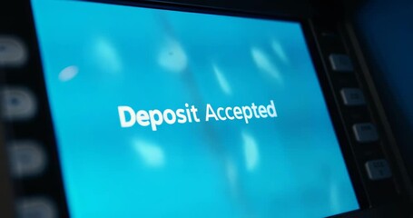 Showing ATM screen displaying deposit accepted while pulsing lights over keypad at bank kiosk - Powered by Adobe