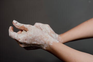 Horizontal close up of female hands kneading soft white clay, illustrating relaxing pottery process and creative handmade hobby.