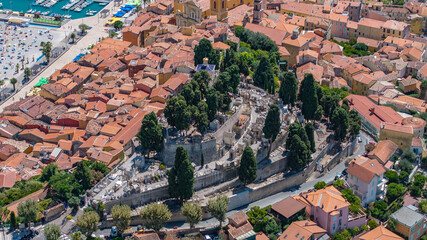 aerial view of area around "Cimetière du Vieux Château" - in old town Menton, French Riviera coastline, with historic buildings,  and parts of port "Vieux Port de Menton" in background