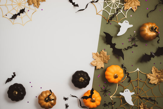 Happy halloween background with party decorations from pumpkins, bats, spiderweb, ghosts top view. Mystic autumn holiday greeting card concept. - Powered by Adobe