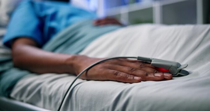 Healthcare, patient or hand with oximeter in hospital, monitor hypertension or heart condition in icu. Medical treatment, recovery or person in emergency care for blood pressure, tech or observation