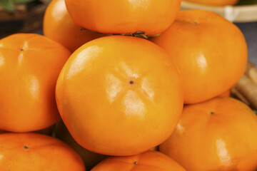 Fresh Sweet Persimmons in Wooden Crate - Ripe Orange Autumn Fruit Display
