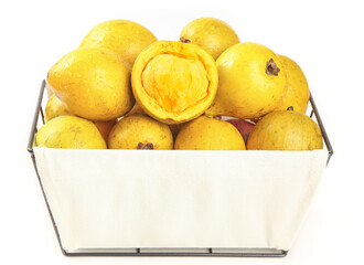 Fresh Yellow Tropical Fruits in Wooden Crate with Cut Half Showing Creamy Interior