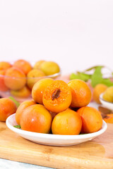 Fresh Ripe Apricots on White Plates with Shallow Depth of Field