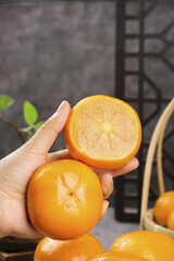 Fresh Persimmons Hand Held Showing Star Pattern Cross Section Sweet Autumn Fruit Specialties