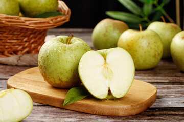 Fresh Green Apples from Shandong China on Rustic Wooden Table with Basket