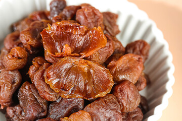Gaozhou Dried Lychee Fruit with Cinnamon Flavored Thick Meat in Ceramic Bowl - Traditional Chinese Delicacy