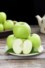 Fresh Tree-Ripened Green Apples from Shaanxi China on Wooden Table with Water Droplets