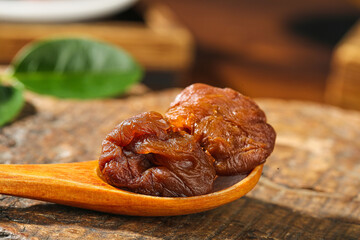 Gaozhou Air-Dried Cinnamon Flavored Lychee on Wooden Spoon - Traditional Chinese Dried Fruit Snack