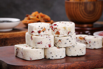 Traditional Nougat Pastry with Rice Powder, Cashews and Sesame Seeds on Wooden Board